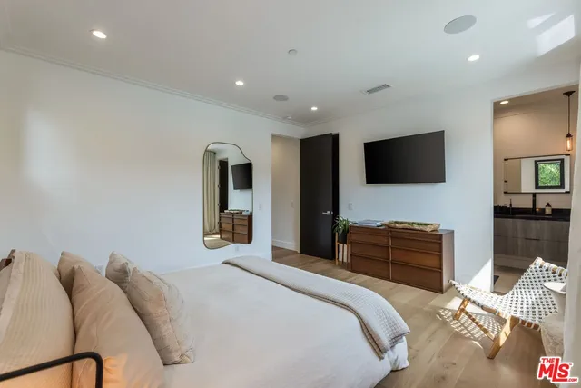 a bedroom with a bed and a flat screen tv