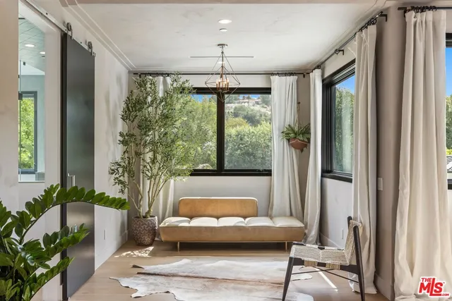 a living room with furniture and a chandelier