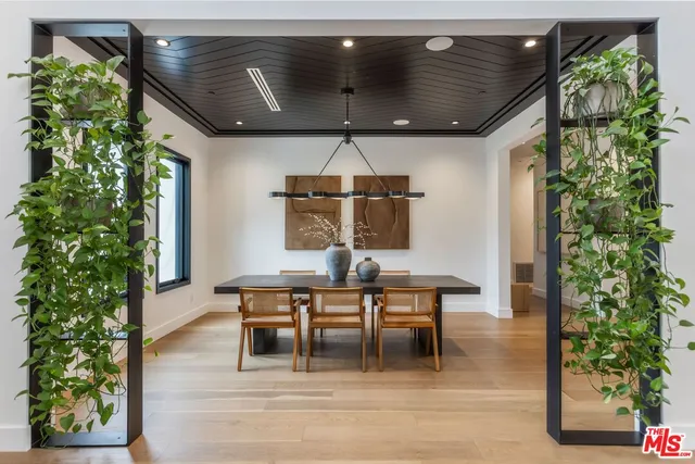 a dining room with lots of green space and chandelier
