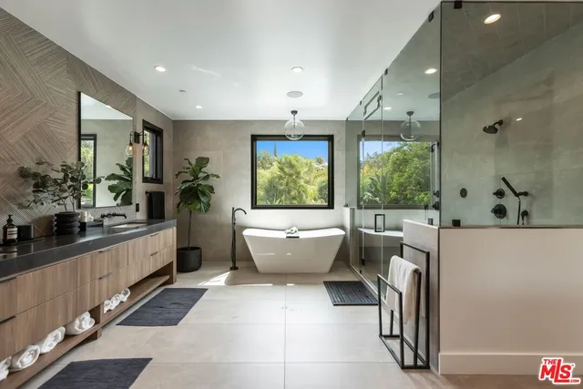 a bathroom with a bathtub a sink and mirror