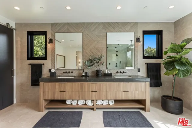 a bathroom with a double vanity sink and a mirror