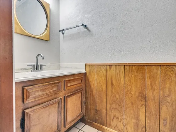 a bathroom with a sink a vanity and a mirror