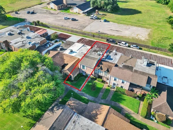 an aerial view of a house with a yard basket ball court and outdoor seating