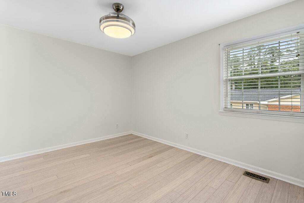 4021 Chaucer Drive Durham, NC 27705 - Photo 16 of 36 a view of a room with wooden floor and window