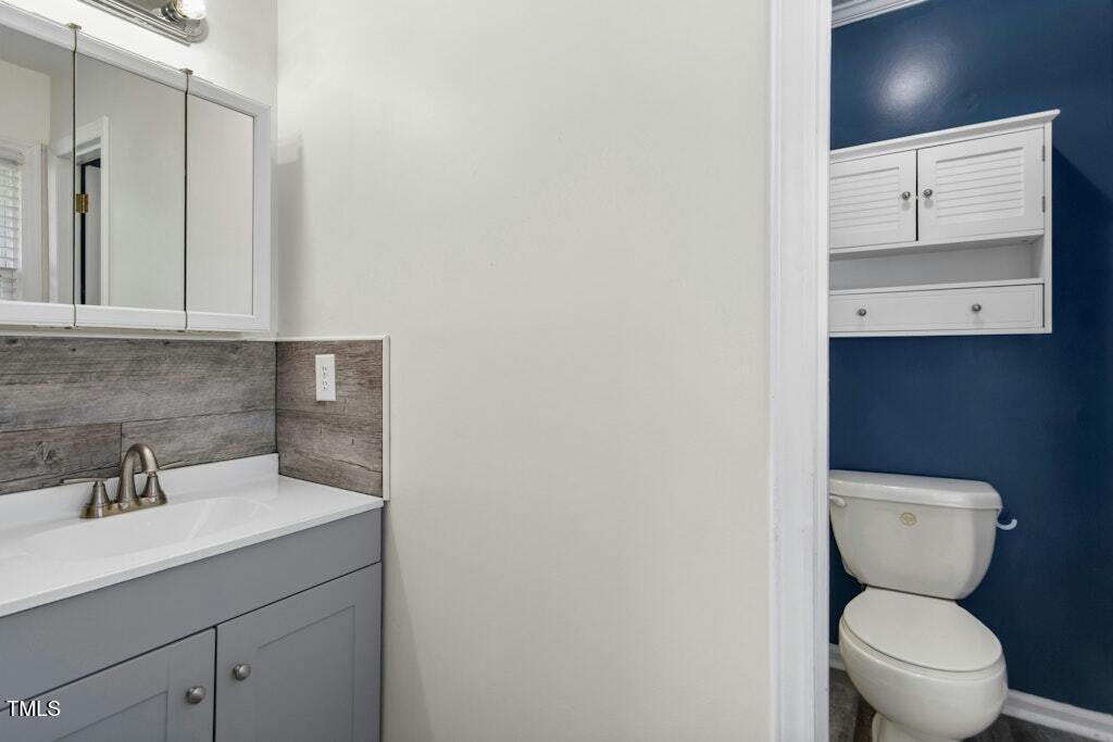 4021 Chaucer Drive Durham, NC 27705 - Photo 20 of 36 a bathroom with a toilet sink and mirror
