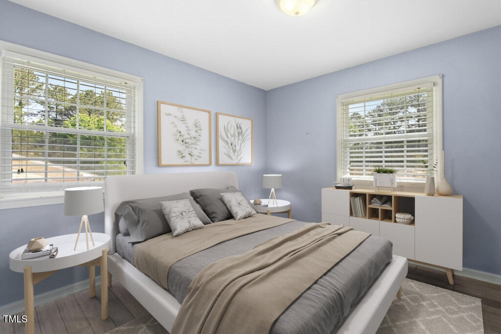 4021 Chaucer Drive Durham, NC 27705 - Photo 22 of 36 a bedroom with a bed and a large window