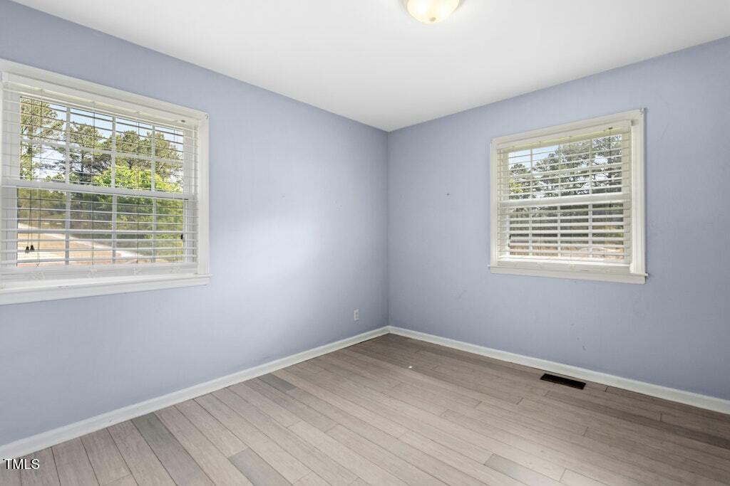 4021 Chaucer Drive Durham, NC 27705 - Photo 23 of 36 a view of a room with wooden floor and windows