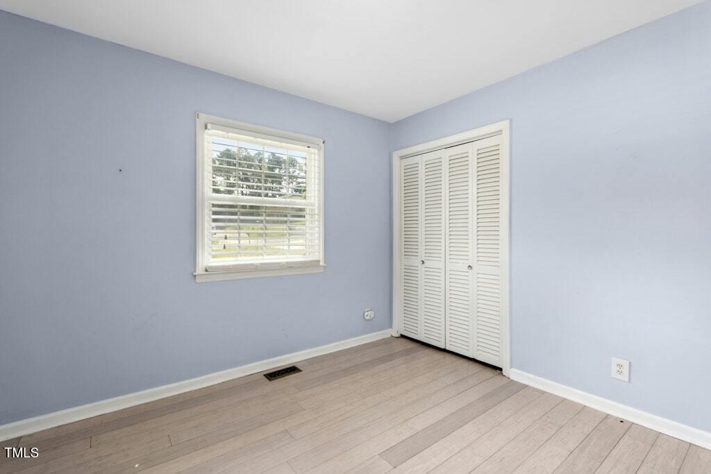4021 Chaucer Drive Durham, NC 27705 - Photo 24 of 36 a view of an empty room with wooden floor and a window