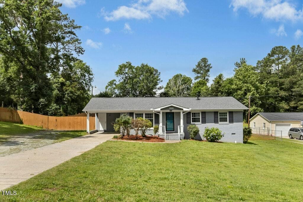 4021 Chaucer Drive Durham, NC 27705 - Photo 3 of 36 a front view of a house with a yard