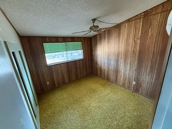 a view of an empty room and a window