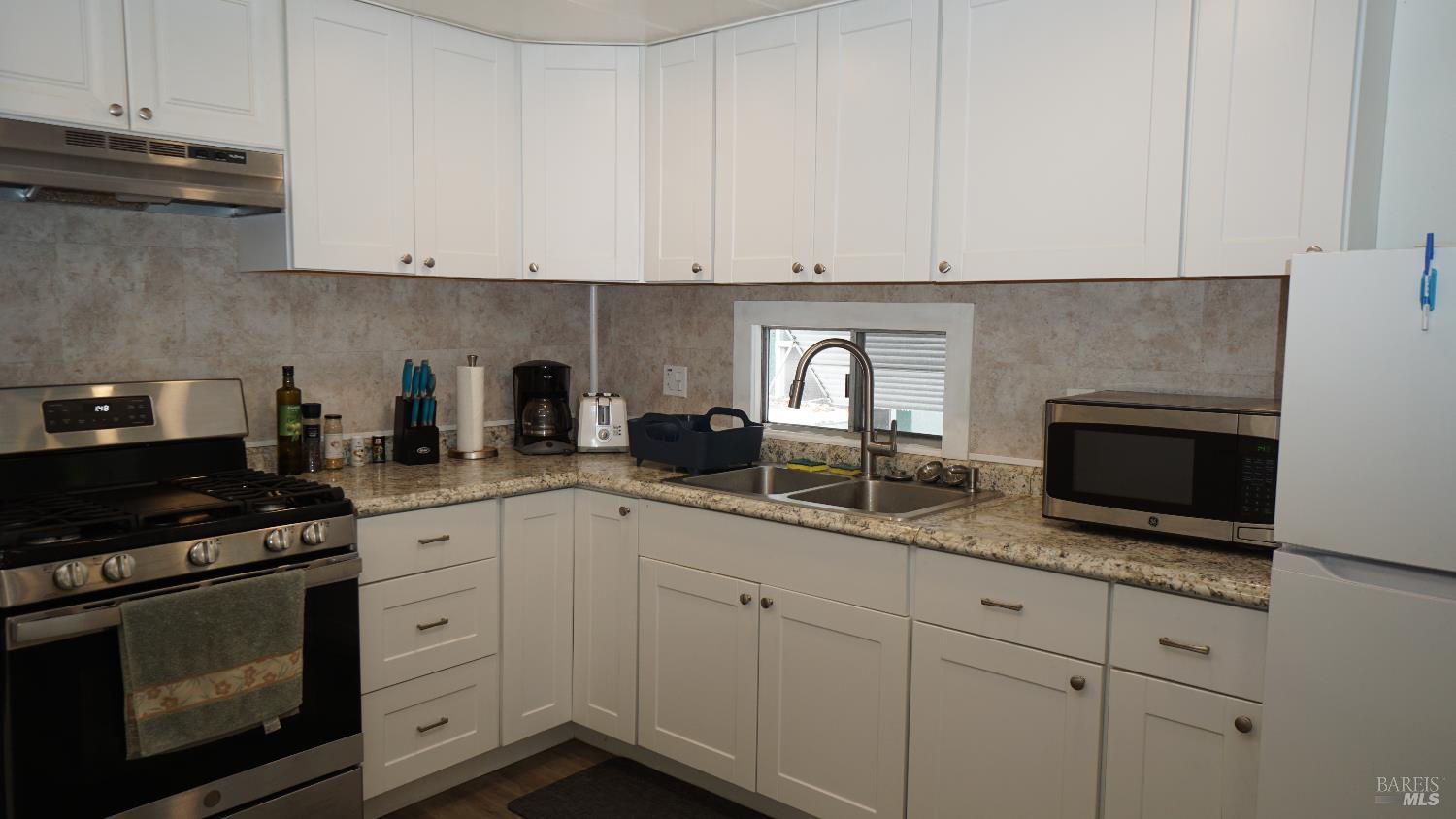 74 Ranchito Court Santa Rosa, CA 95403 - Photo 7 of 21 Beautiful white cabinetry with almost new full gas range, refrigerator, stainless steel sink