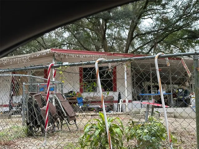 a view of a patio with table and chairs