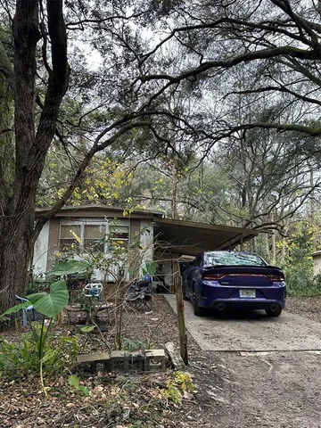 a backyard of a house with barbeque oven fire pit table and chairs