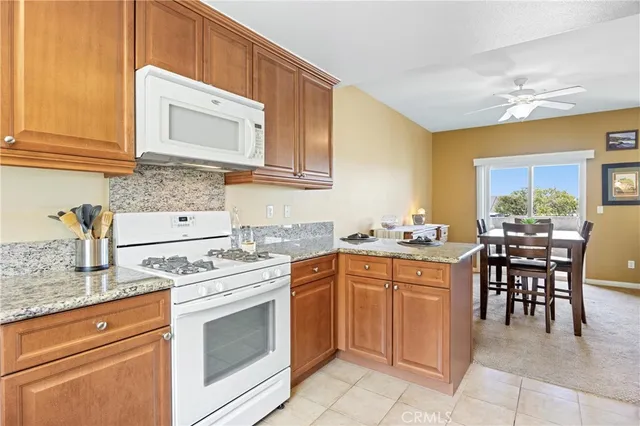 a kitchen with a stove sink and cabinets