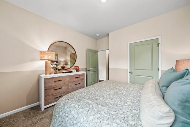 a bedroom with a bed and a dresser