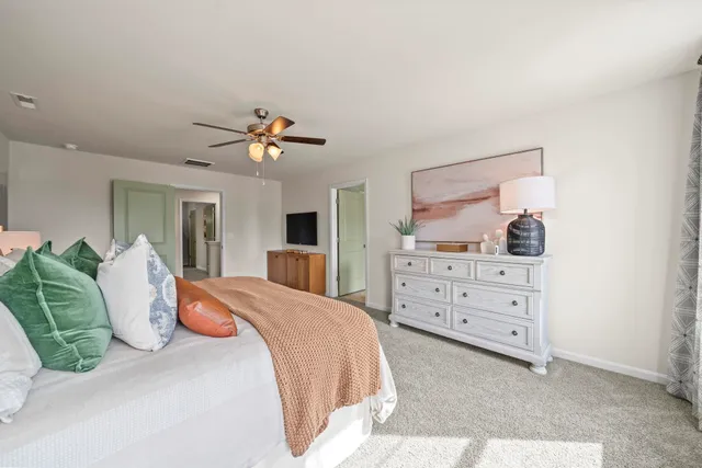 a bedroom with a large bed and a dresser