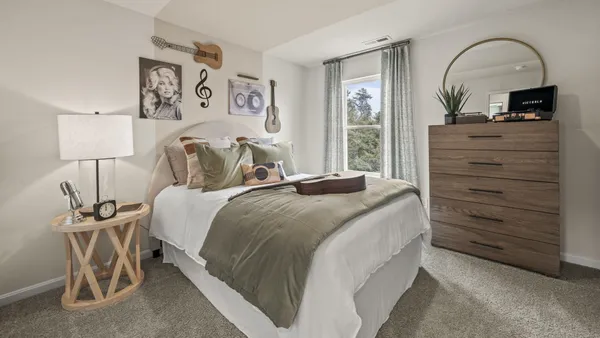 a bedroom with a bed and a dresser