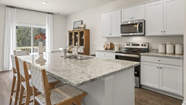 a kitchen with stainless steel appliances granite countertop a kitchen island hardwood floor sink stove and granite counter top