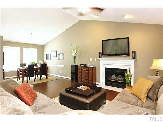 2341 Millstaff Court Raleigh, NC 27613 - Photo 3 of 16 a living room with furniture a flat screen tv and a fireplace