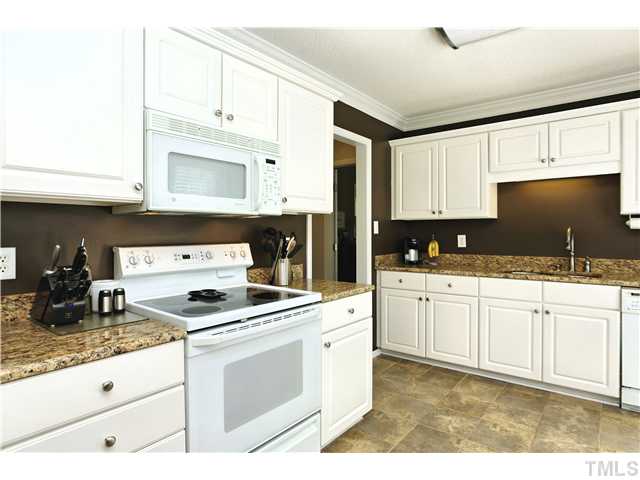 2341 Millstaff Court Raleigh, NC 27613 - Photo 7 of 16 a kitchen with granite countertop a sink stove and cabinets