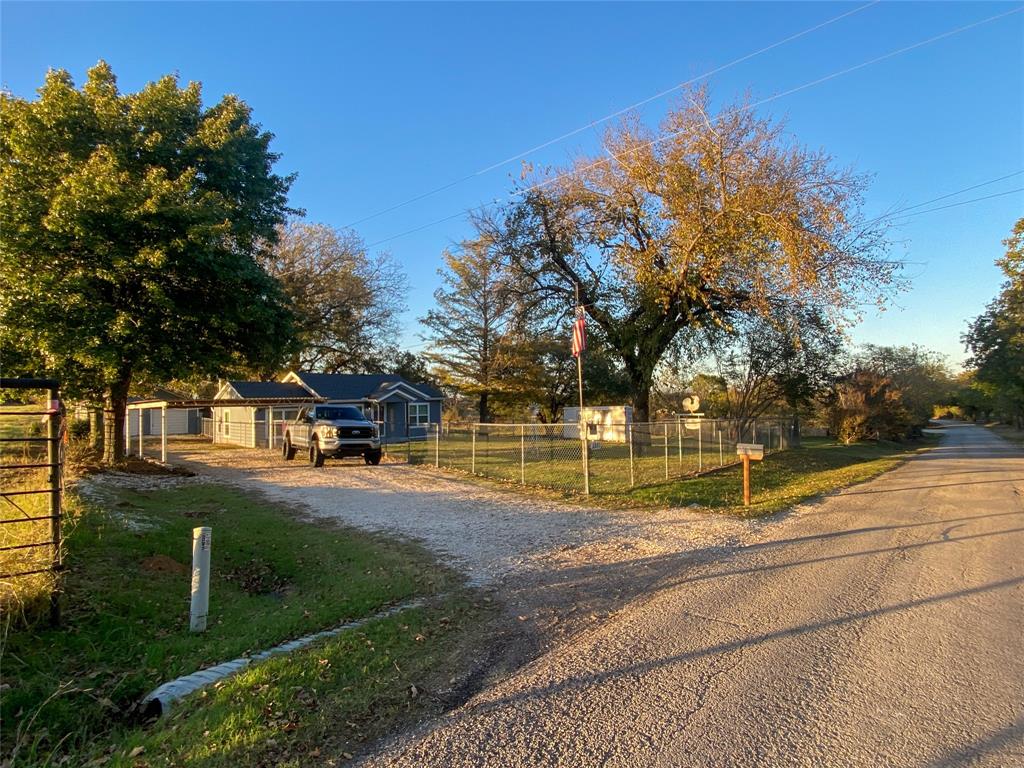 a view of backyard of house with green space