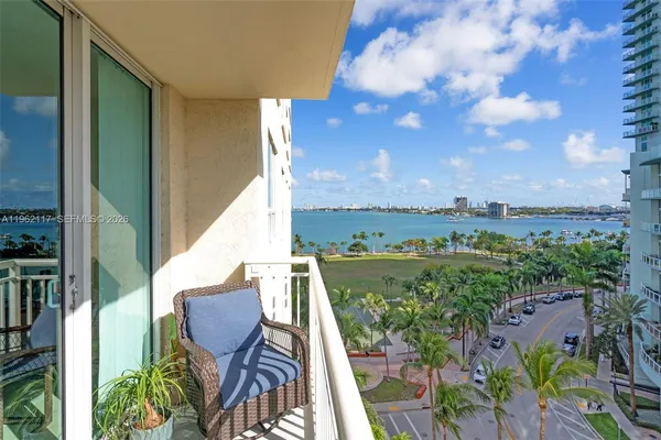 a view of a balcony with furniture and city view
