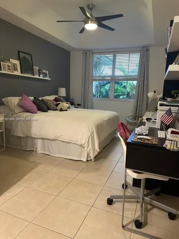 a bedroom with a bed and a desk