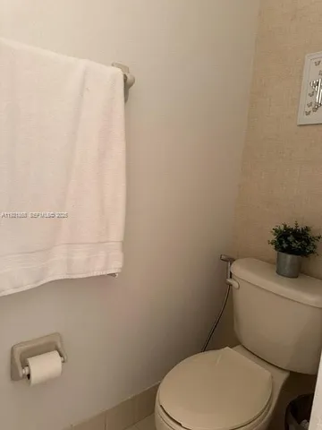 a white toilet sitting next to a white sink