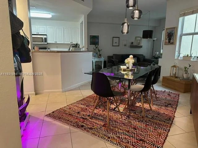 a living room with stainless steel appliances kitchen island granite countertop furniture and a kitchen view