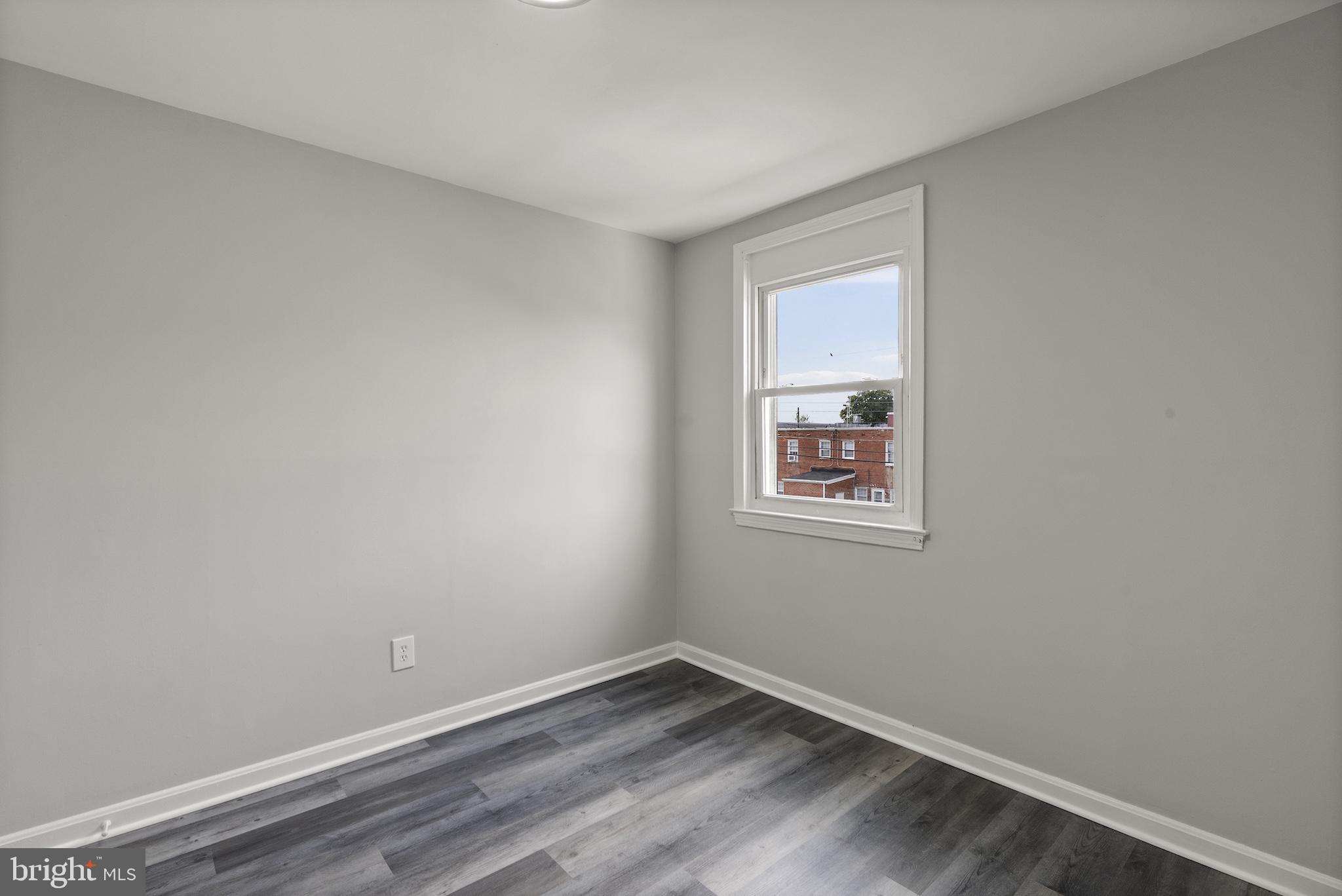 8059 Gray Haven Road Dundalk, MD 21222 - Photo 15 of 22 a view of an empty room with wooden floor and a window