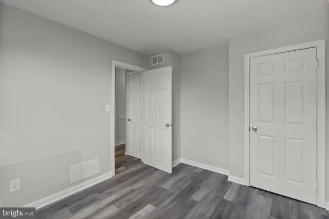 a view of an empty room and wooden floor