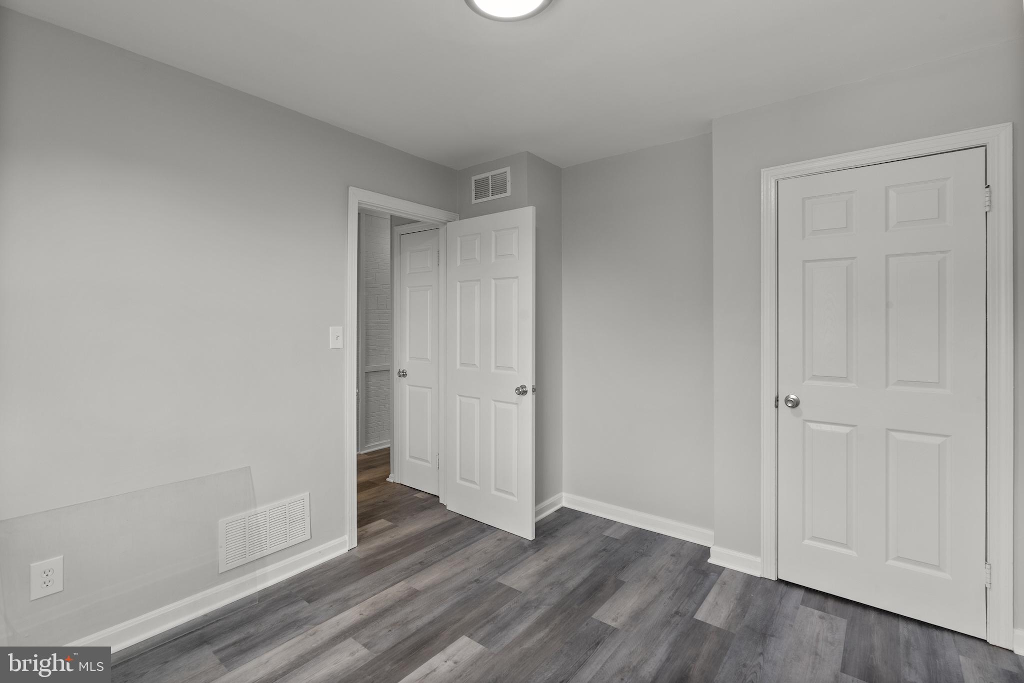 8059 Gray Haven Road Dundalk, MD 21222 - Photo 16 of 22 a view of an empty room and wooden floor