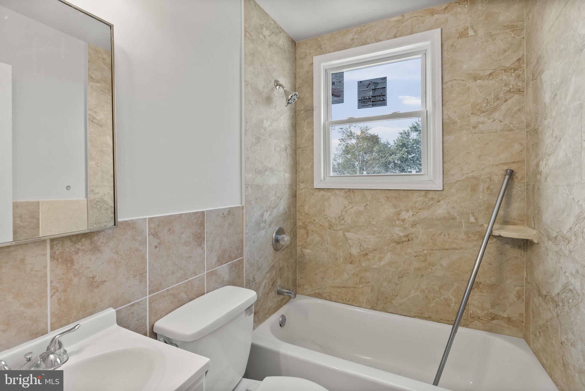 8059 Gray Haven Road Dundalk, MD 21222 - Photo 18 of 22 a bathroom with a bathtub and a shower