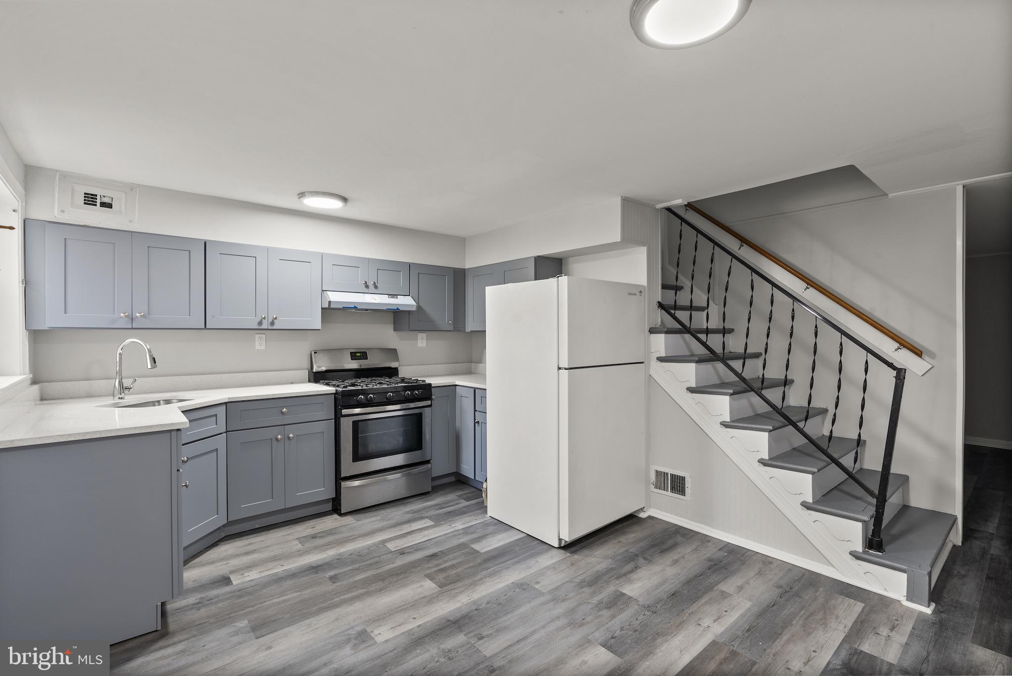 8059 Gray Haven Road Dundalk, MD 21222 - Photo 4 of 22 a kitchen with sink a microwave and stove