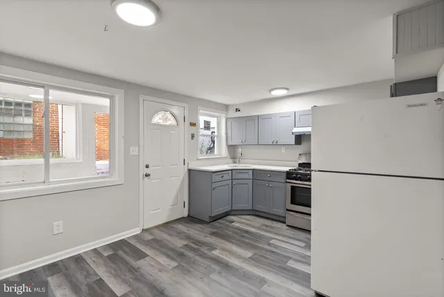 a kitchen with a refrigerator stove top oven and sink