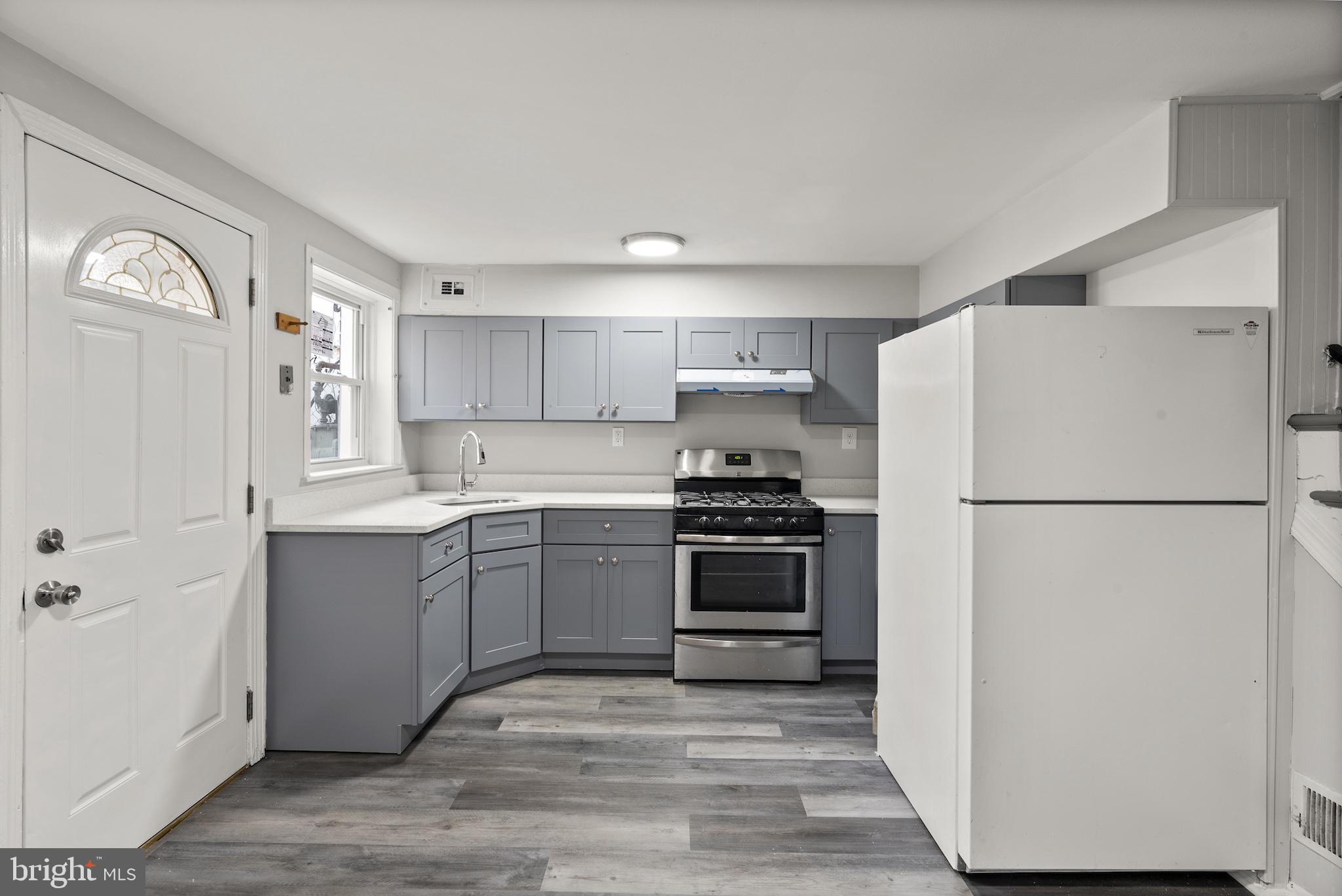 8059 Gray Haven Road Dundalk, MD 21222 - Photo 6 of 22 a kitchen with a refrigerator and a stove top oven