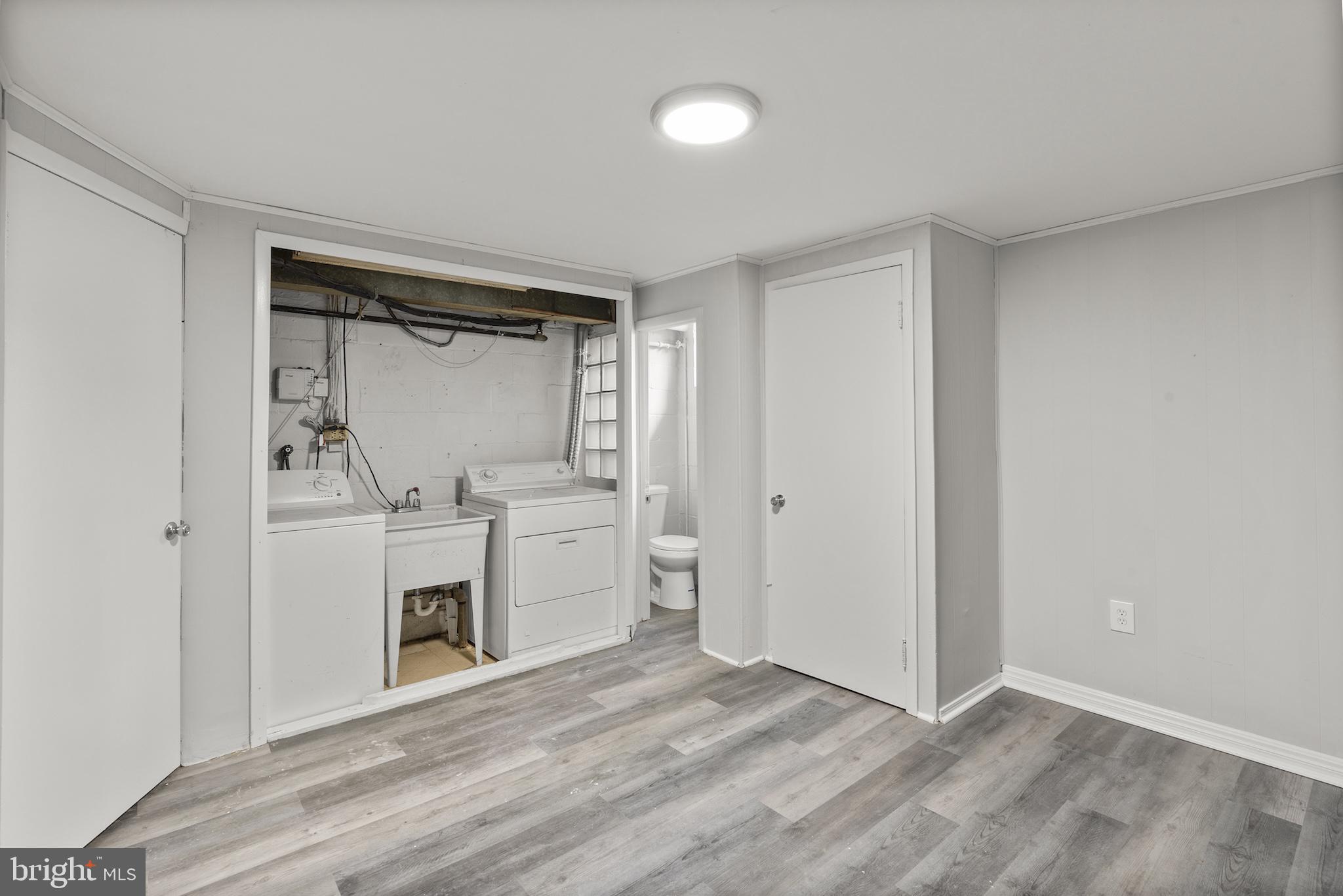 8059 Gray Haven Road Dundalk, MD 21222 - Photo 8 of 22 a view of a storage & utility room with washer and dryer