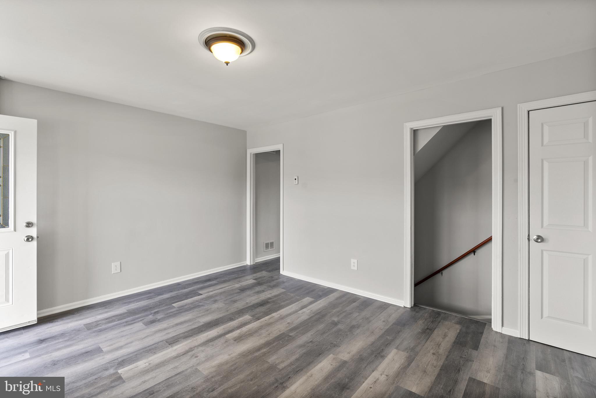 8059 Gray Haven Road Dundalk, MD 21222 - Photo 10 of 22 an empty room with wooden floor and windows