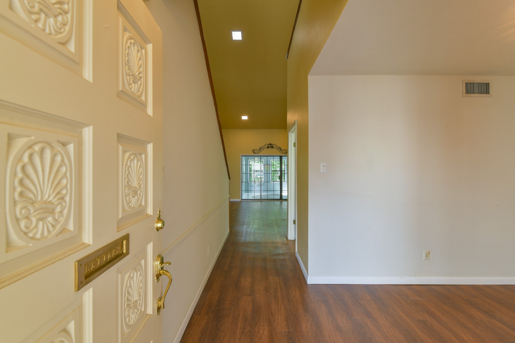 325 East Main Street Brenham, TX 77833 - Photo 4 of 9 a view of a hallway with wooden floor