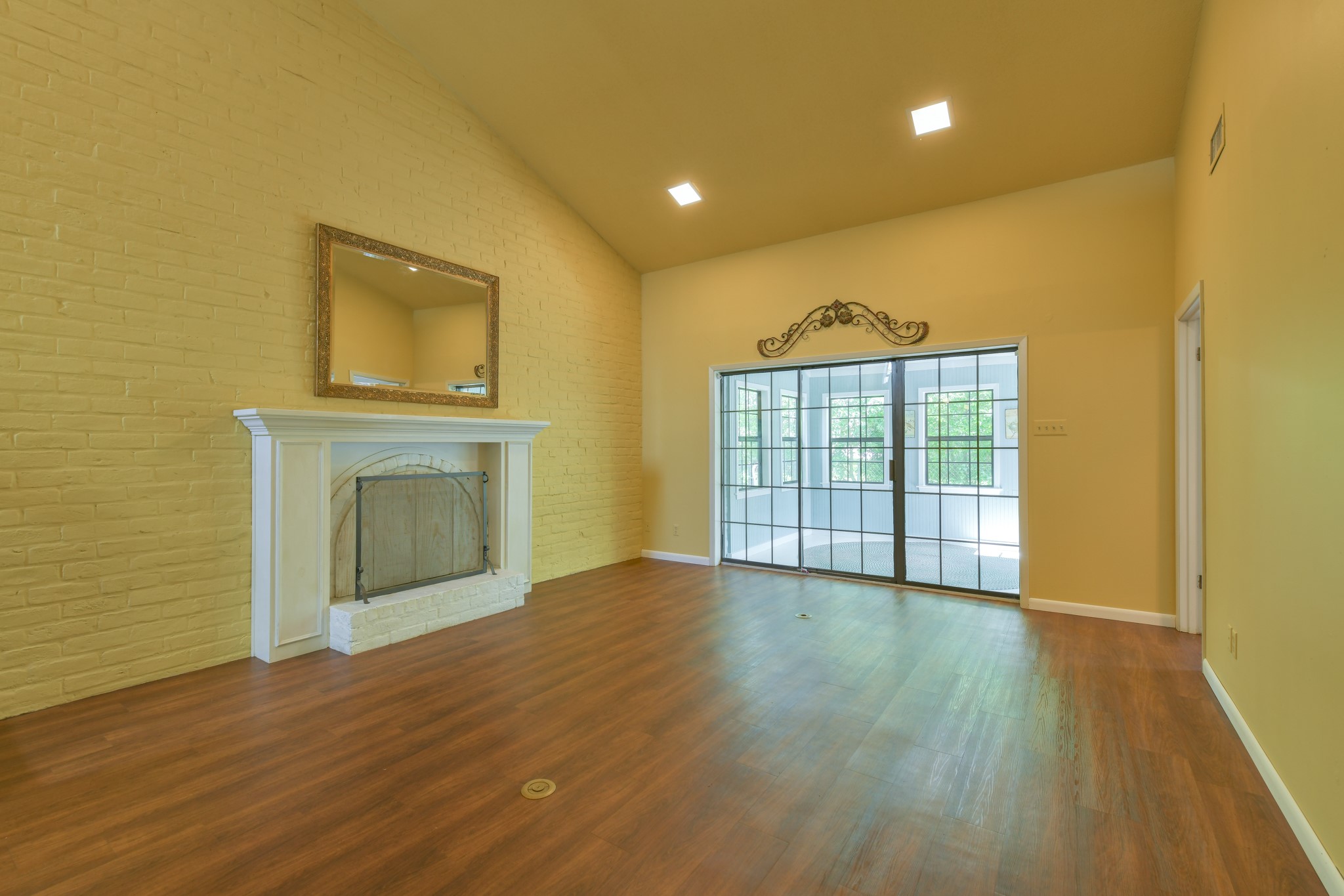 325 East Main Street Brenham, TX 77833 - Photo 6 of 9 a view of an empty room with wooden floor and a window