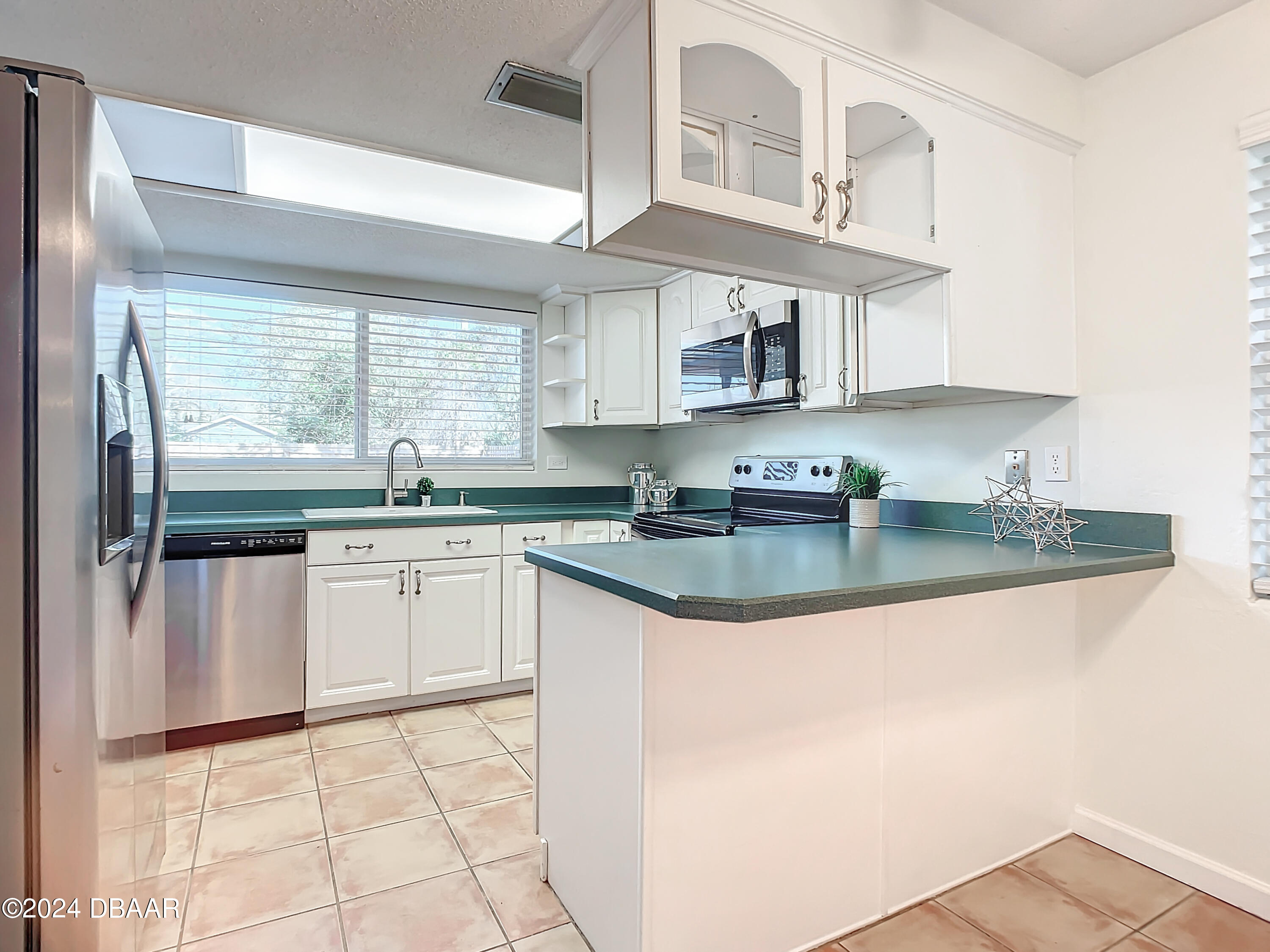 55 Merrywood Circle Ormond Beach, FL 32174 - Photo 15 of 64 a kitchen with stainless steel appliances granite countertop a sink and a stove