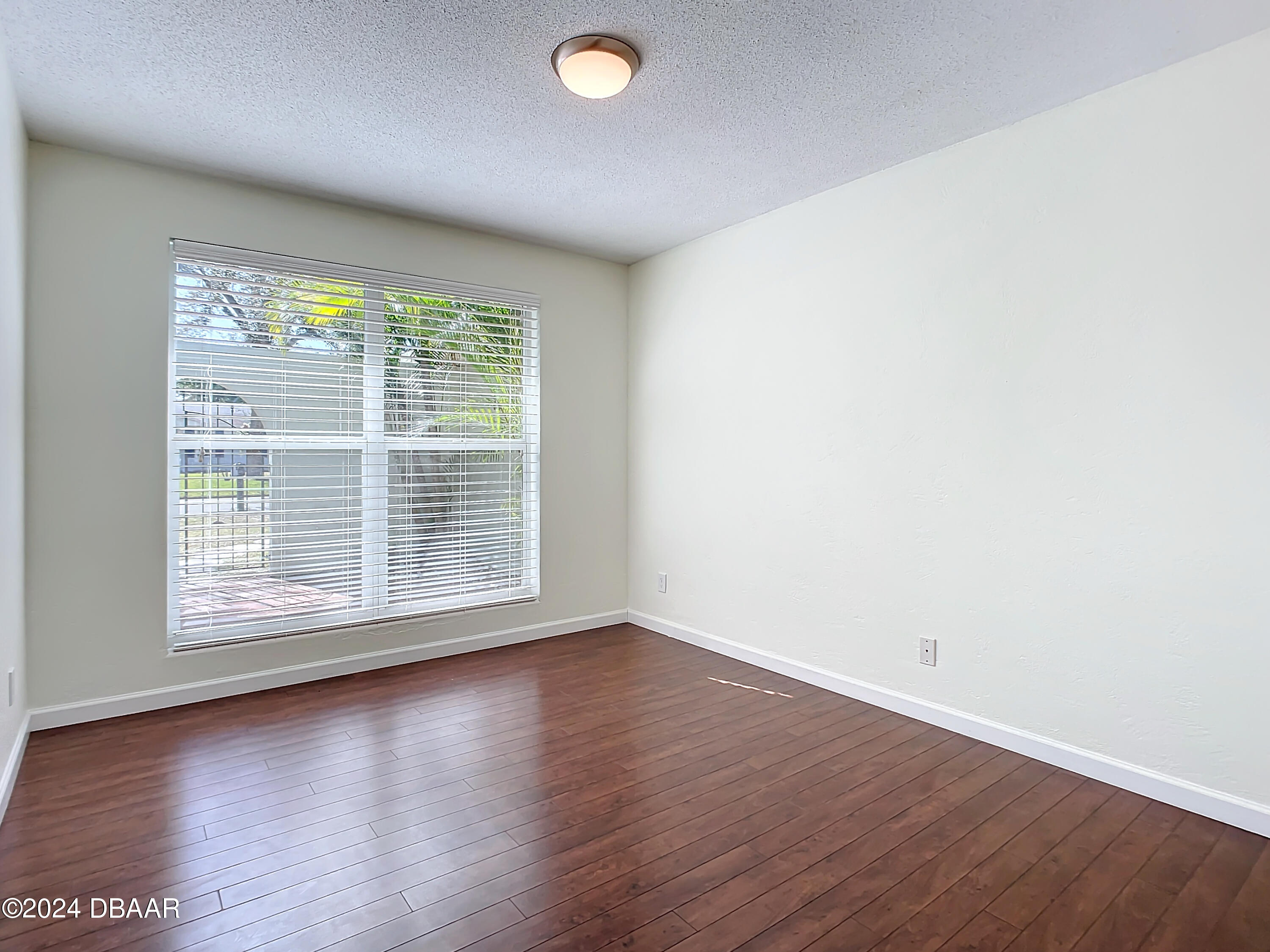 55 Merrywood Circle Ormond Beach, FL 32174 - Photo 26 of 64 an empty room with wooden floor and windows