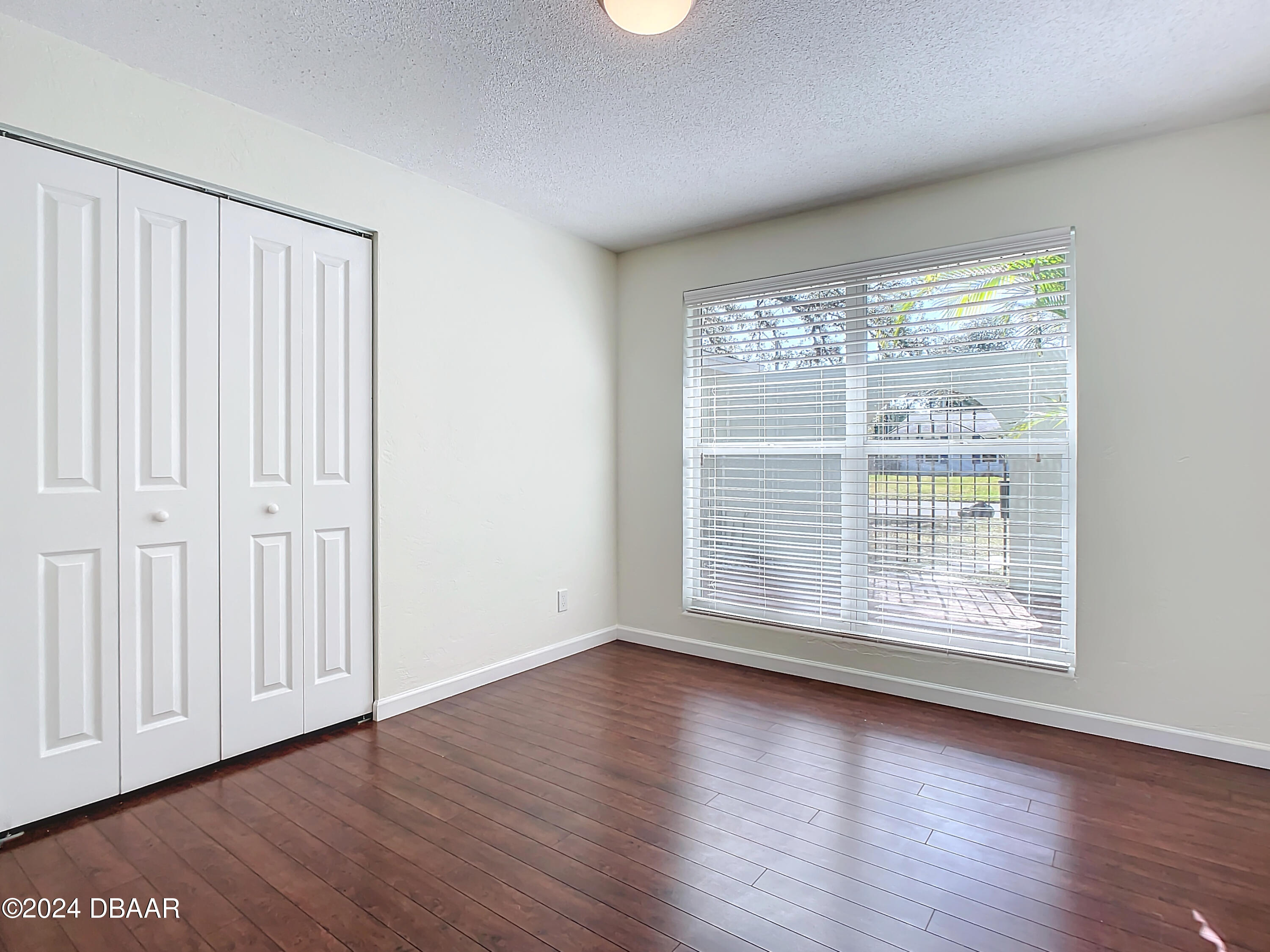55 Merrywood Circle Ormond Beach, FL 32174 - Photo 27 of 64 a view of an empty room with wooden floor and a window