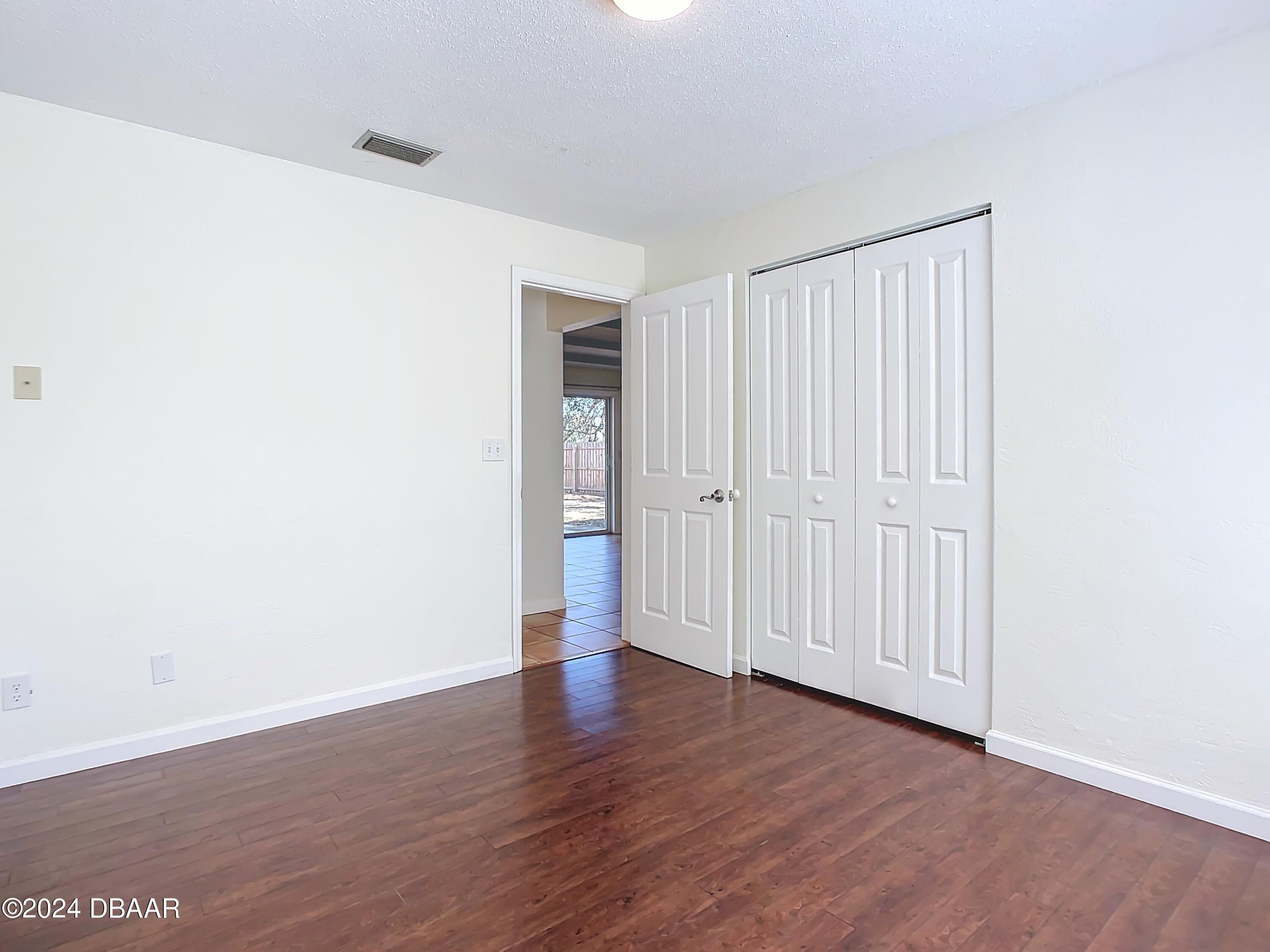 55 Merrywood Circle Ormond Beach, FL 32174 - Photo 28 of 64 an empty room with wooden floor