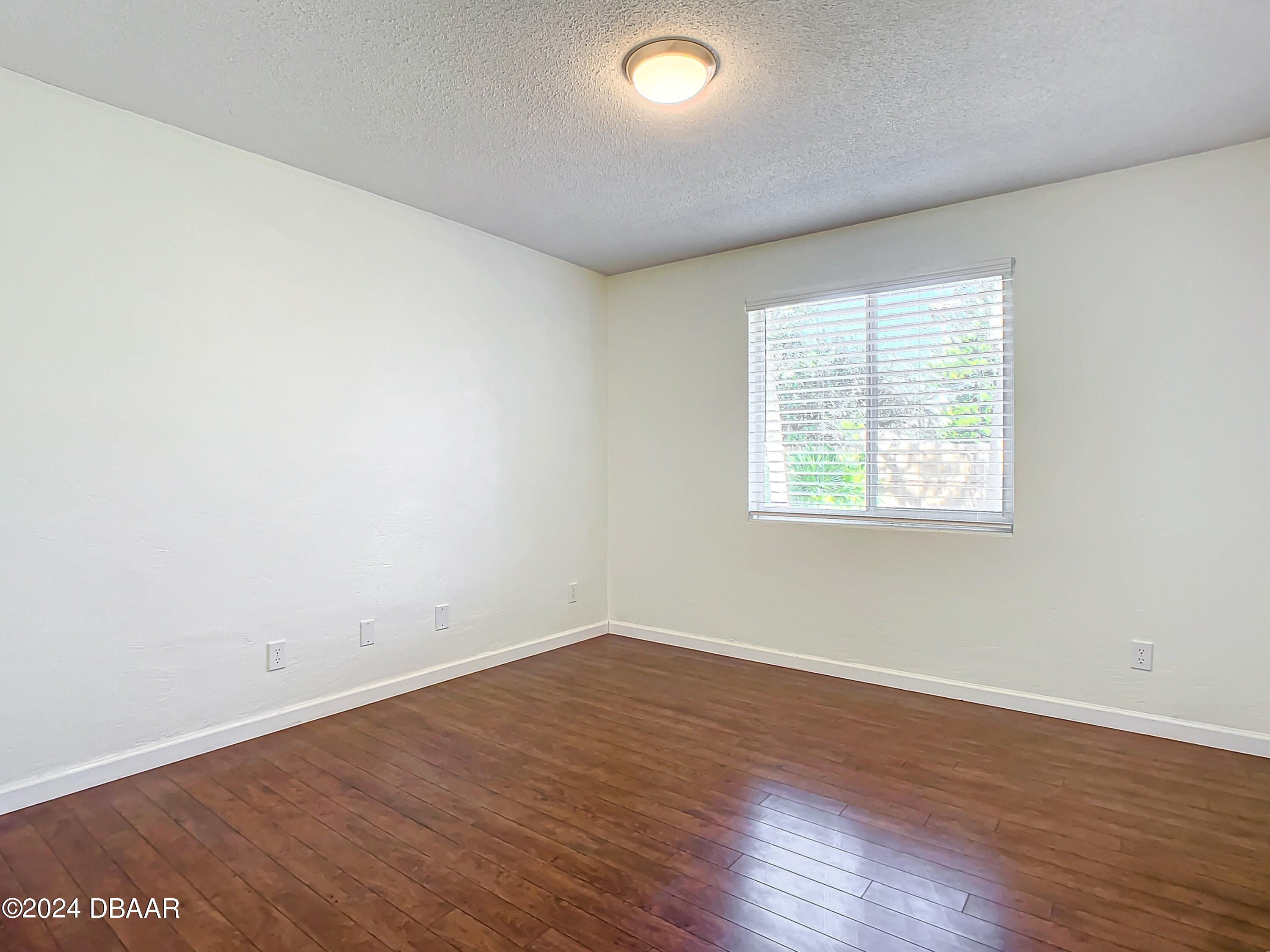 55 Merrywood Circle Ormond Beach, FL 32174 - Photo 31 of 64 an empty room with wooden floor and windows