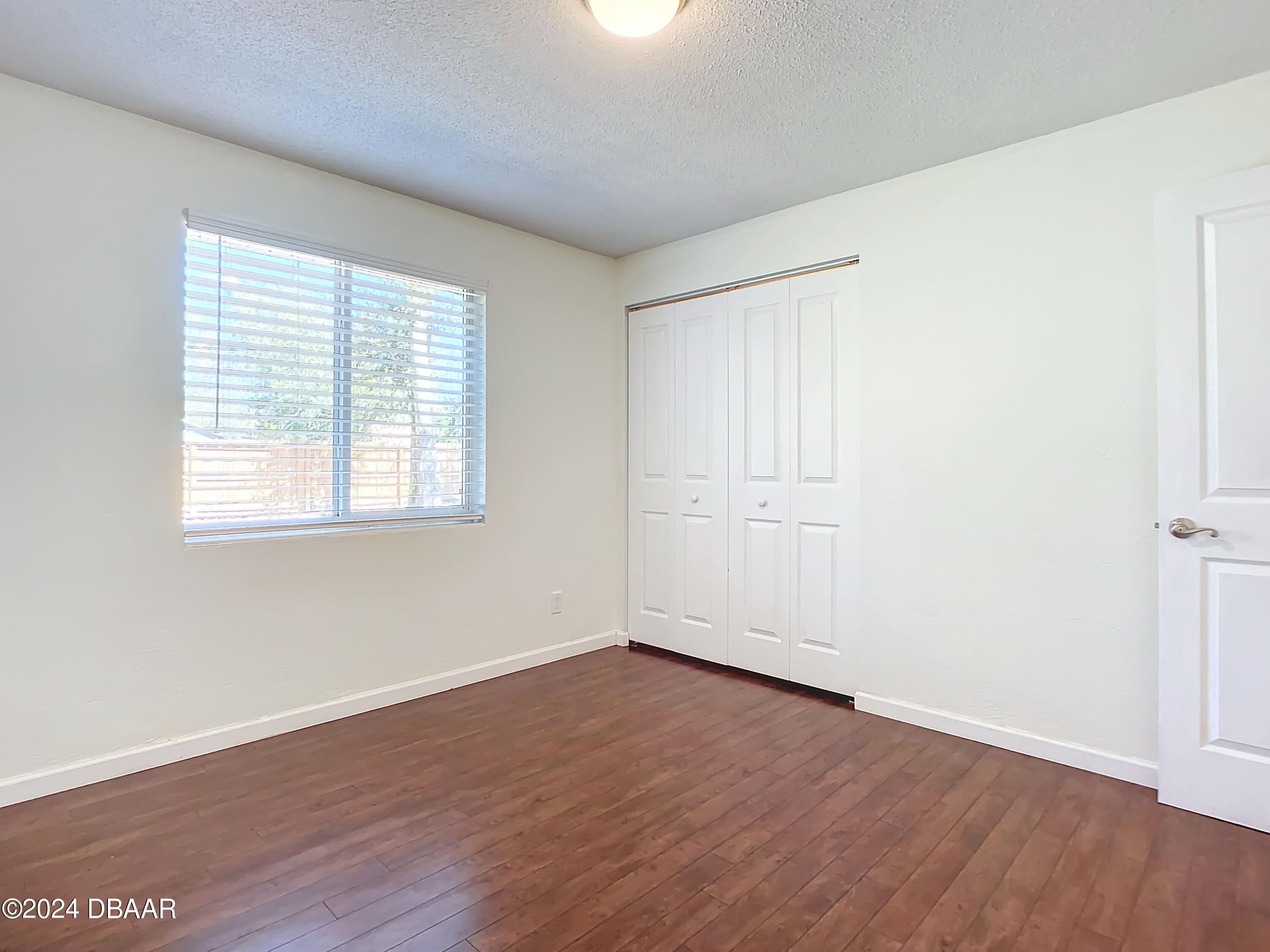 55 Merrywood Circle Ormond Beach, FL 32174 - Photo 32 of 64 an empty room with wooden floor and windows