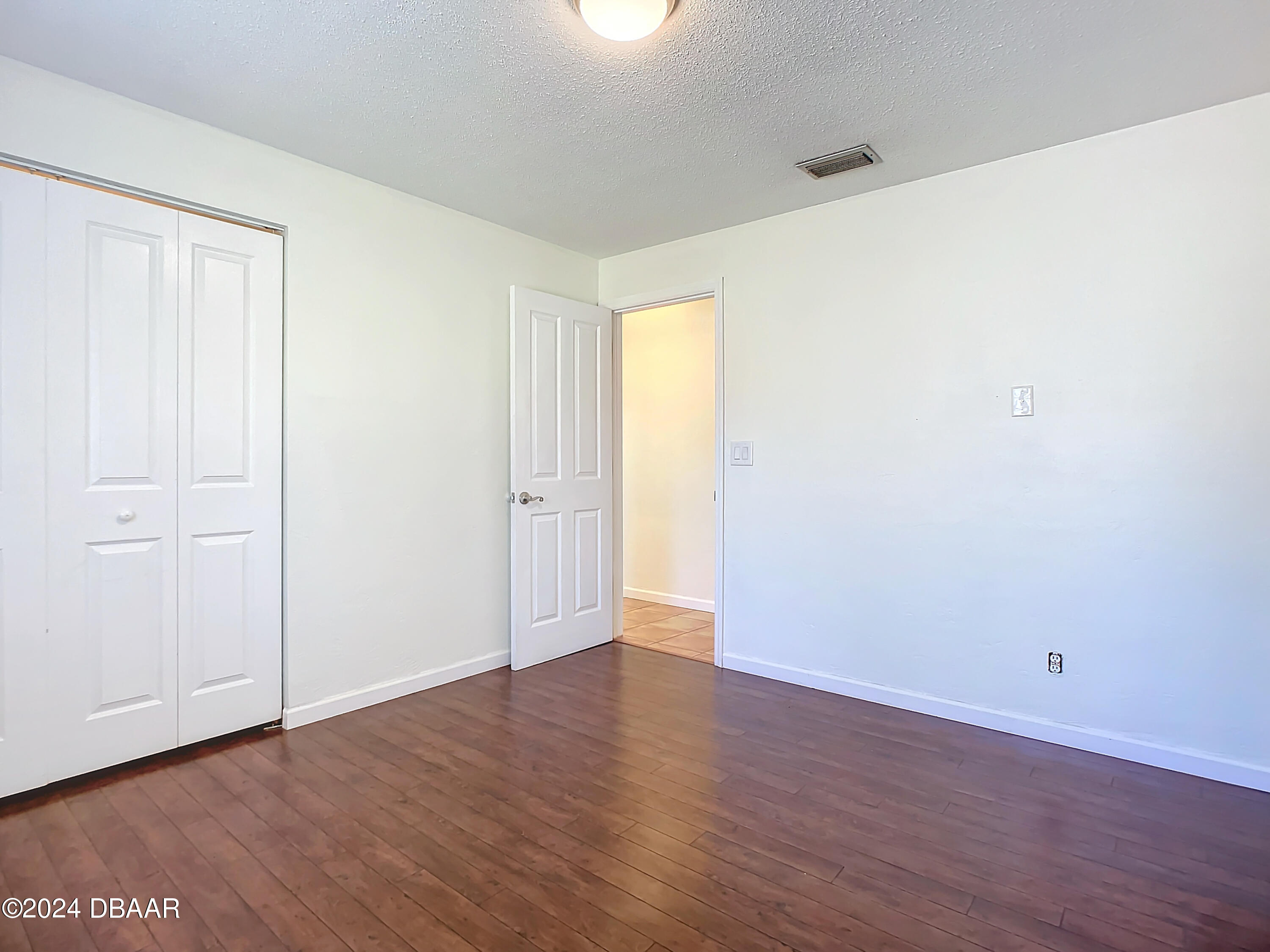 55 Merrywood Circle Ormond Beach, FL 32174 - Photo 33 of 64 a view of an empty room with wooden floor