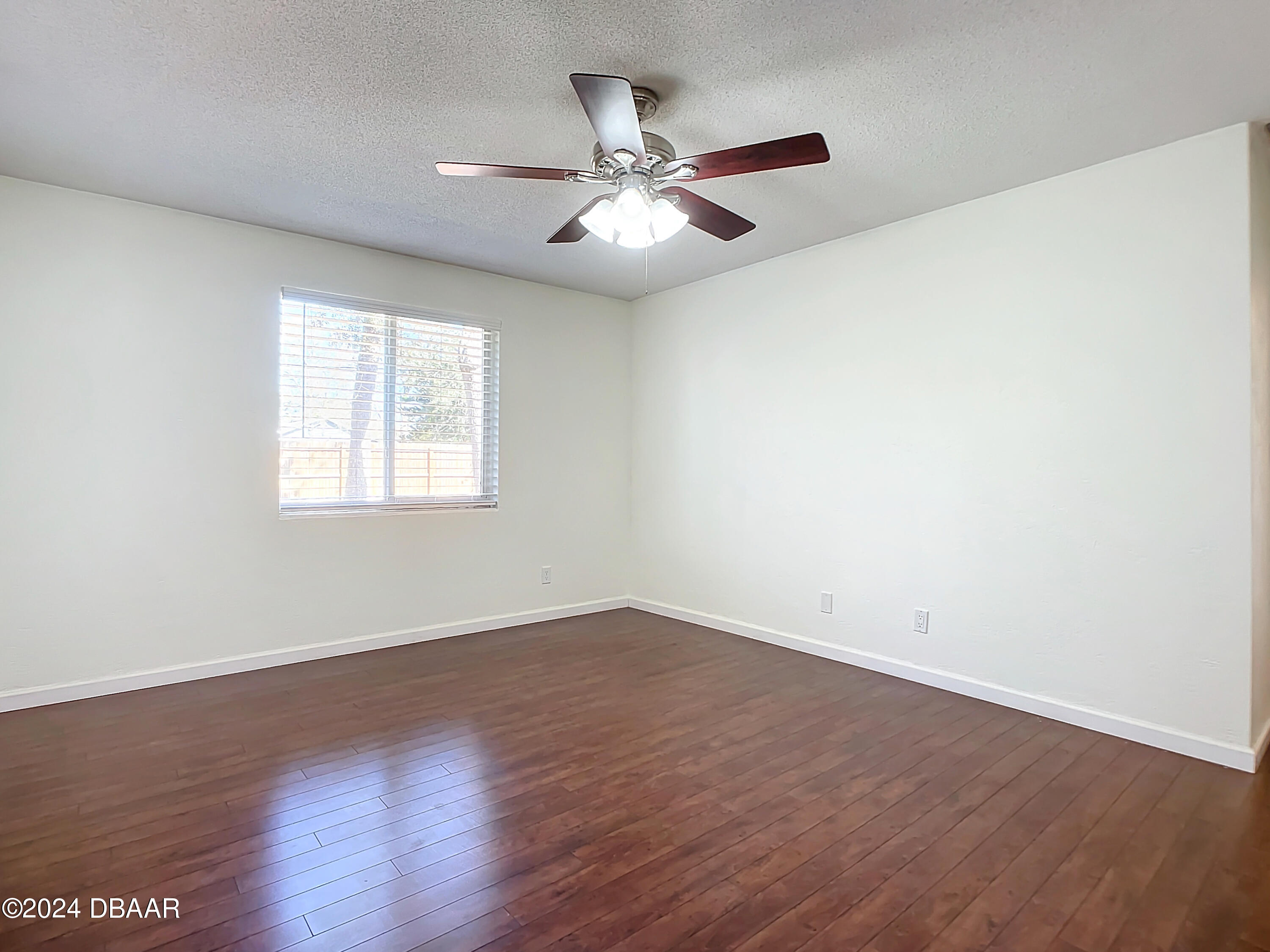55 Merrywood Circle Ormond Beach, FL 32174 - Photo 36 of 64 an empty room with wooden floor fan and windows