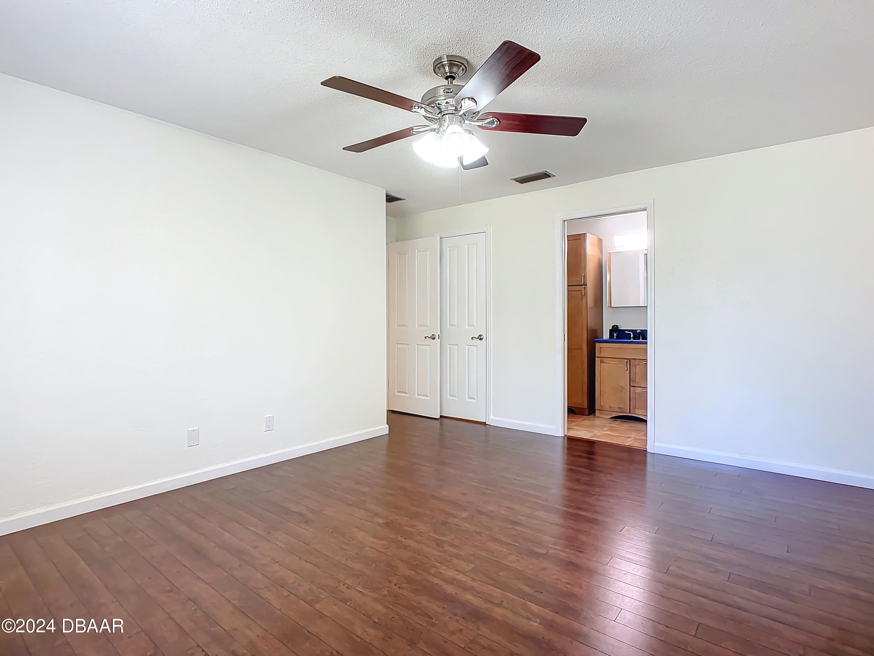 55 Merrywood Circle Ormond Beach, FL 32174 - Photo 37 of 64 an empty room with wooden floor ceiling fan and windows