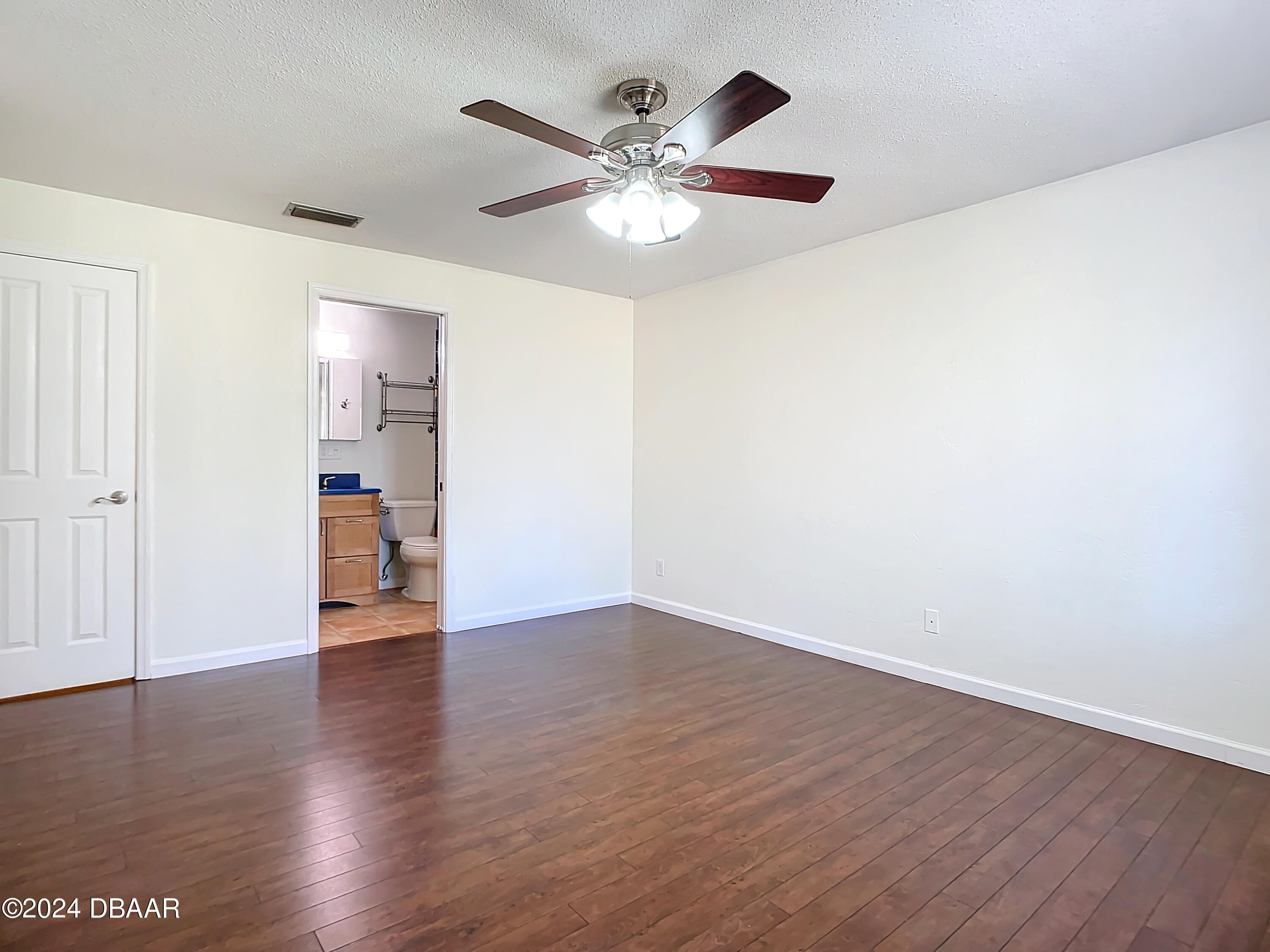 55 Merrywood Circle Ormond Beach, FL 32174 - Photo 38 of 64 an empty room with wooden floor chandelier fan and windows